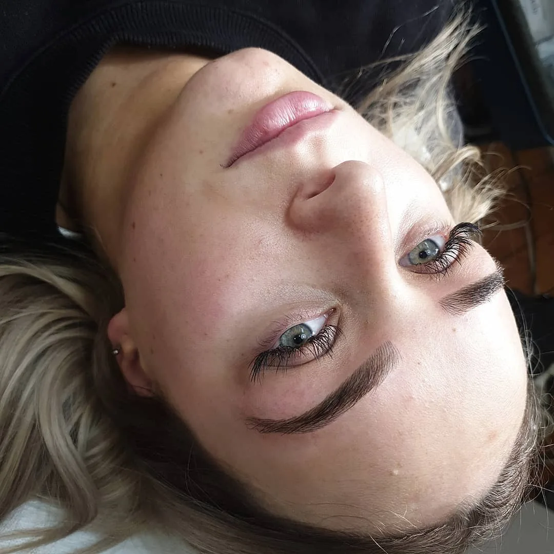 Sculpted, brushed-up brow on a client resting on the studio bed