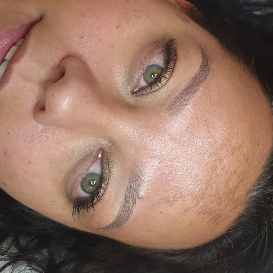 Softly defined natural brows, close crop on a resting client